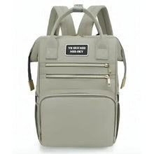 Light gray maternity travel backpack with front zip pockets and adjustable shoulder straps