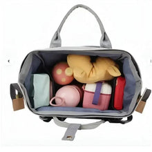 Light gray maternity travel backpack with open top showing interior compartments