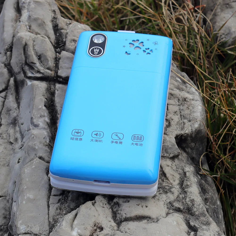 Mumzar blue clamshell women flip phone dual sim shown closed on rock background with camera