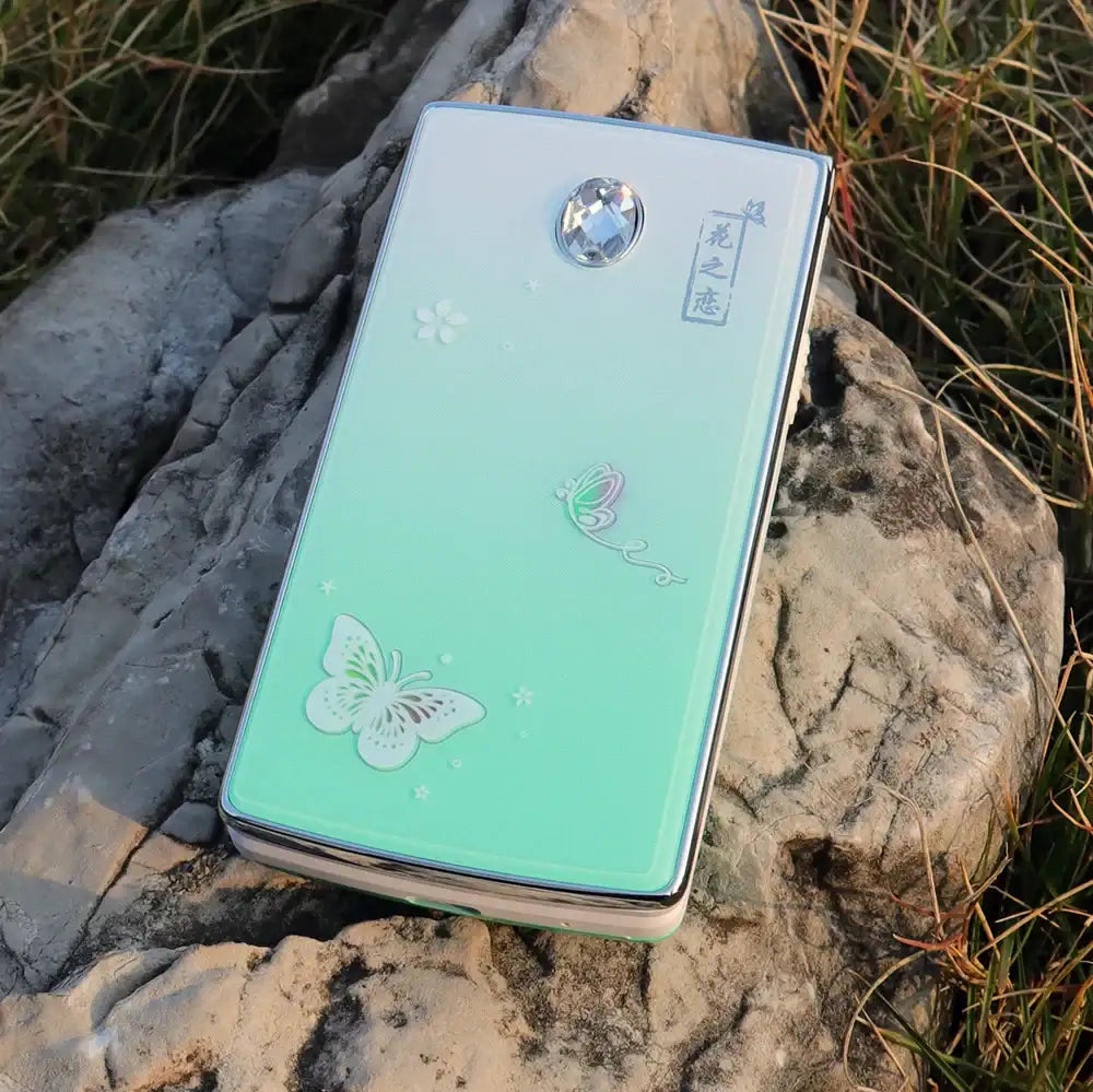 Mumzar women flip phone dual sim mint green clamshell with butterfly design jeweled cover floral accents on rock