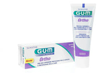 Gum Ortho toothpaste box and gel tube, white packaging with purple branding.