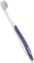 Gum orthodontic toothbrush with soft bristles, compact head, purple handle, angled close-up