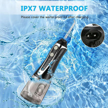 Portable oral irrigator with black-and-silver body and angled nozzle for water cleaning