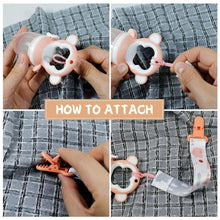 Baby pacifier clip being attached to a pacifier on a hand