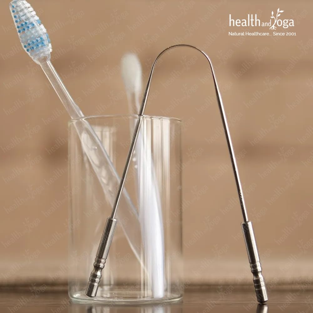 HealthAndYoga metal tongue cleaner stainless steel tongue scraper standing in glass with toothbrush