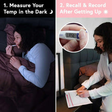 Digital basal body thermometer being measured in bed, LCD screen reading visible