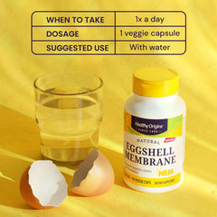 Healthy Origins eggshell membrane supplement for joint health bottle with glass of water and eggshells on yellow background