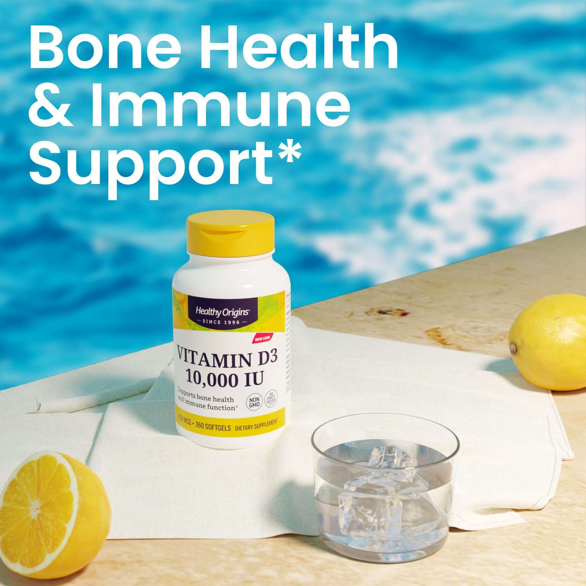 Healthy Origins Vitamin D3 bottle on table with lemons and glass by pool Vitamin D3 10000 IU supplement UAE