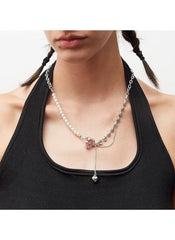 Huitich heart pendant pearl necklace worn on model with black top featuring mixed chain and pearl details