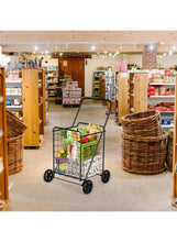 Heavy-duty shopping cart trolley with mesh basket holding produce, four wheels for mobility