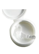 Cleansing balm jar with creamy balm texture and white spatula