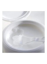 Cleansing balm close-up with spatula spread of creamy texture