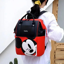 Red and black baby travel backpack worn with shoulder straps; Mickey-style front print