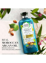 Argan oil of Morocco shampoo bottle with leaves and flowers around it