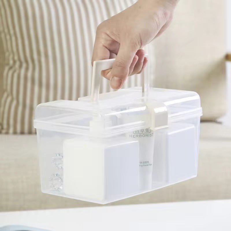 Clear plastic medication organizer case with handle being held for easy transport and storage