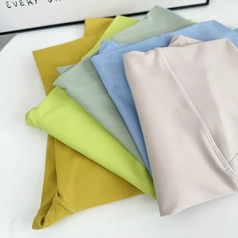 Colorful assortment of high waist push up leggings for women stacked neatly for stylish workout wear