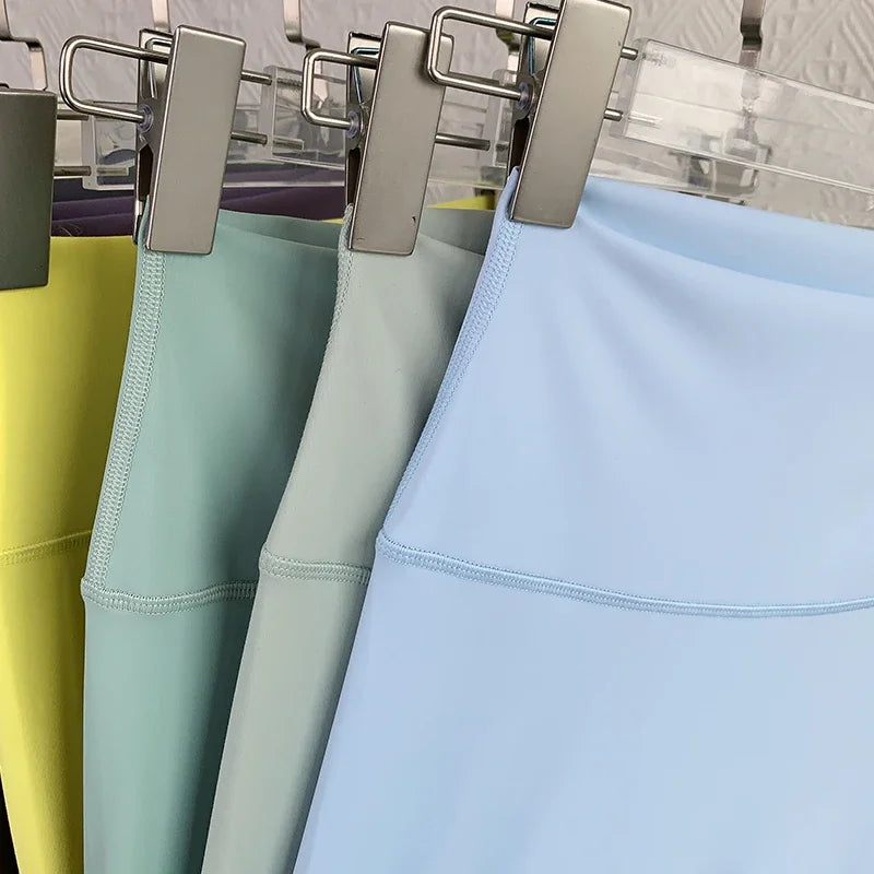 Mumzar high waist yoga leggings UAE in various pastel colors hanging on display