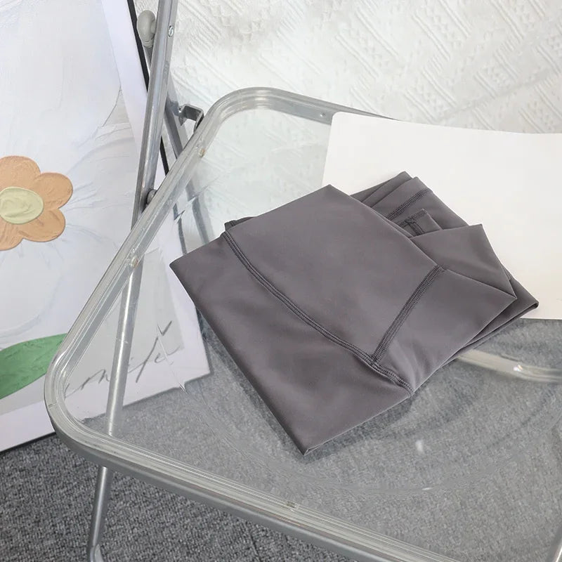 Mumzar high waist yoga leggings UAE folded neatly on a modern chair