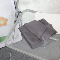 Mumzar high waist yoga leggings UAE folded neatly on a modern chair