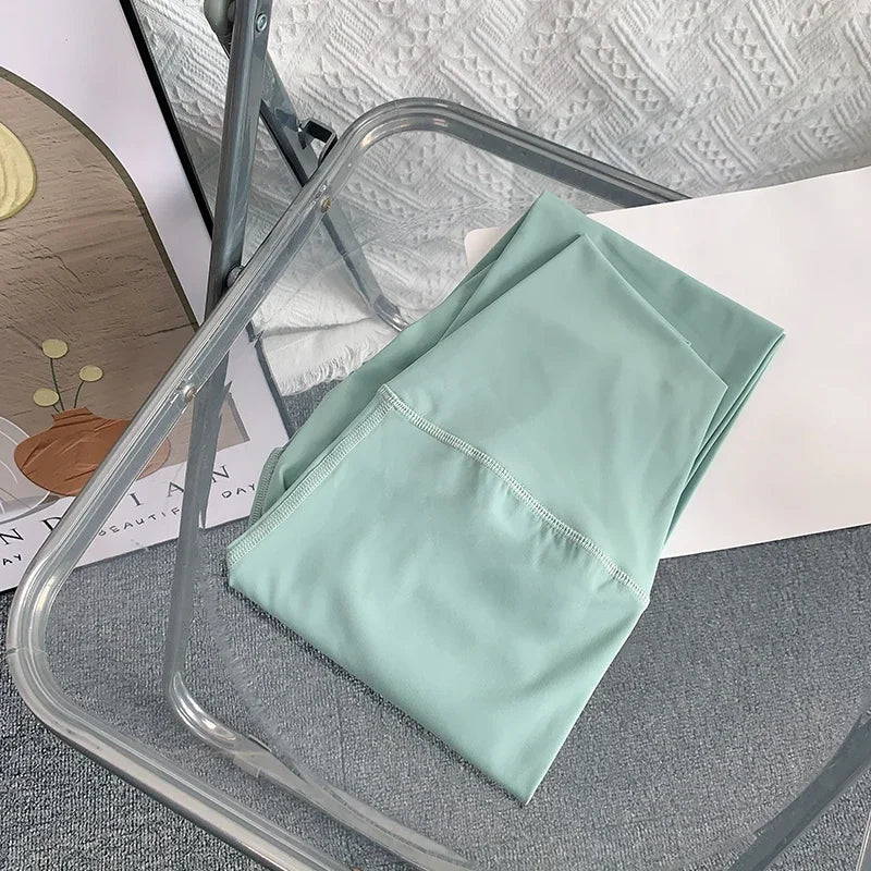 Mint Green Mumzar High Waist Yoga Leggings UAE folded on a transparent chair