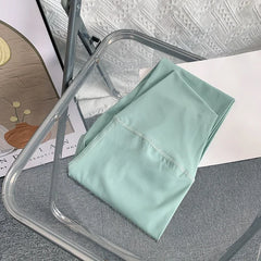 Mint Green Mumzar High Waist Yoga Leggings UAE folded on a transparent chair