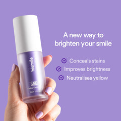 Hand holding Hismile v34 Colour Corrector purple bottle against lavender background showing product name and benefits