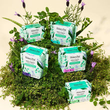 Assorted boxed overnight herbal-infused menstrual pads with organic cotton cover designs