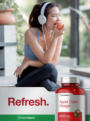 Young woman in workout gear eating an apple next to a Horbaach apple cider vinegar bottle 2400mg apple cider vinegar capsules