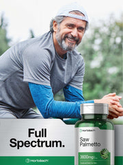 Bottle of saw palmetto extract supplement 3600mg with smiling active middle aged man outdoors