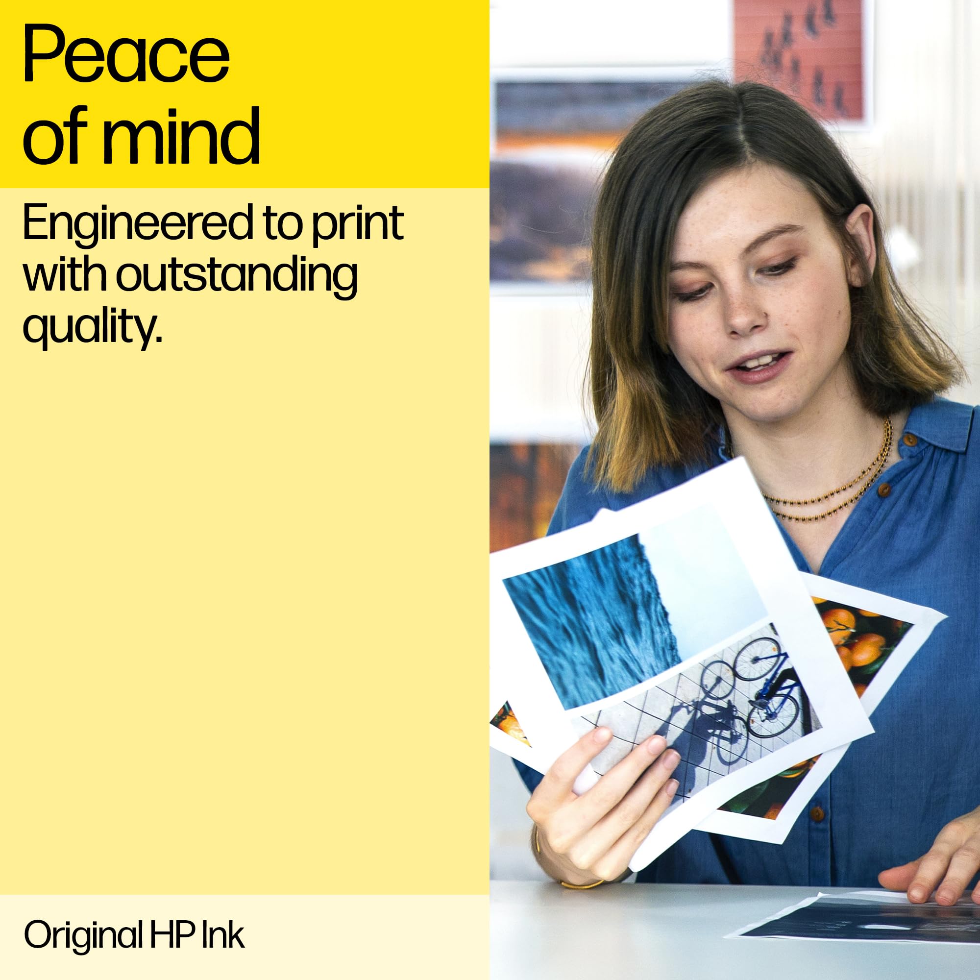 Woman reviewing high-quality photo prints made with original HP ink for DeskJet printers