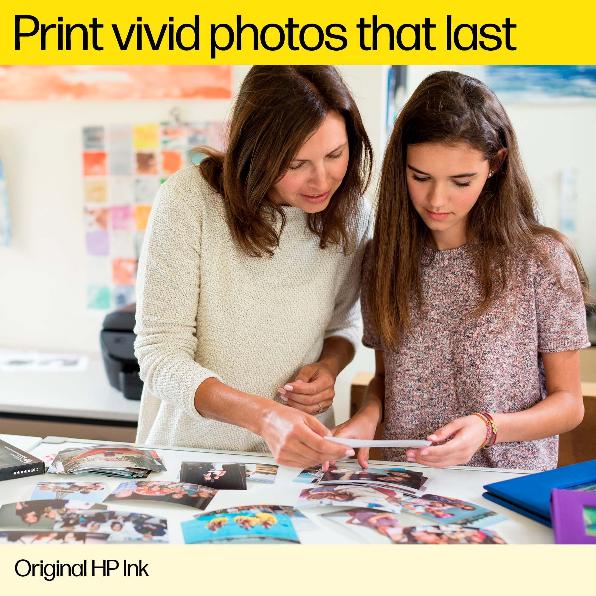 Mother and daughter looking at printed photos using original HP ink for DeskJet printers