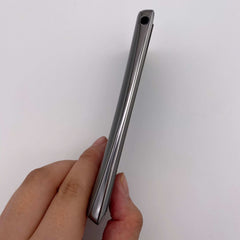Side profile of silver Sony Ericsson Xperia Arc S refurbished held in hand showing slim metal frame and headphone jack