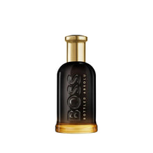 Parfum bottle with black glass body and gold cap, embossed BOSS logo.