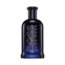 Men's fragrance bottle with black cap and dark blue glass