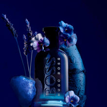 Hugo Boss eau de toilette bottle with blue flowers beside it