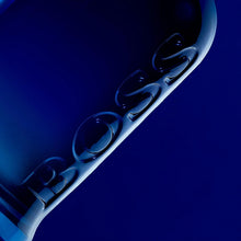 Hugo Boss eau de toilette bottle detail, embossed lettering on dark glass