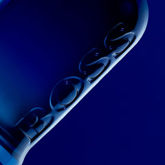 Close-up of Hugo Boss Eau De Toilette 100ml price embossed on dark blue glass bottle
