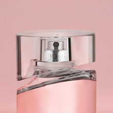 Front view of pink perfume bottle with silver mirrored cap and nozzle