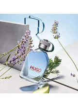 HUGO perfume bottle with purple flower sprigs and a green citrus slice