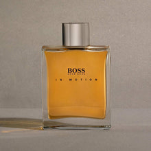 Men's fragrance bottle with amber liquid and silver cap, minimal front view with logo label.