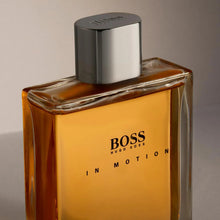 Men's fragrance bottle with amber liquid and silver cap, front label showing BOSS IN MOTION.