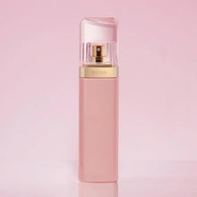 Light pink eau de parfum bottle with clear faceted cap and gold collar