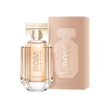 Striped glass eau de parfum bottle with gold spray cap and beige box