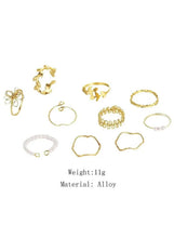 Assorted gold-tone rings in a 10-piece set, plus one light rhinestone ring