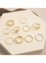 10-piece ring set laid out on tray: mixed gold-tone and silvertone rings