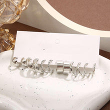 Silver-tone hoop and drop earrings with pearl charms on a display card