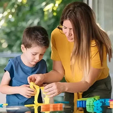 Adult and child creating a clay figure with yellow modeling clay