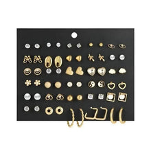 Assorted gold and silver tone earring set with studs, hearts, hoops, and pearls