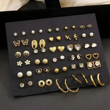Gold and silver earring set with mixed studs, hearts, hoops, and pearl accents