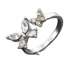 Crystal butterfly ring with silver-tone band and five clear stones, side view